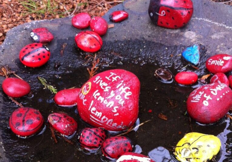Painted ladybug rocks, set on basalt column; all photos taken by Ecoyards